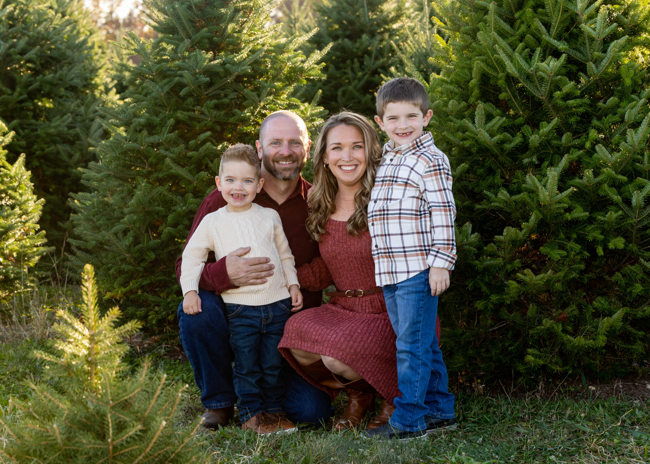 Smiling family of four at tree farm